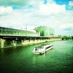 A photograph of a boat going down a river in Berlin.