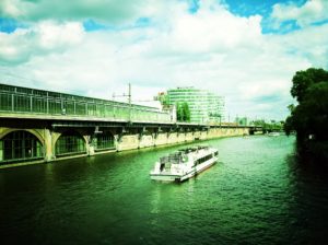 A photograph of a boat going down a river in Berlin.