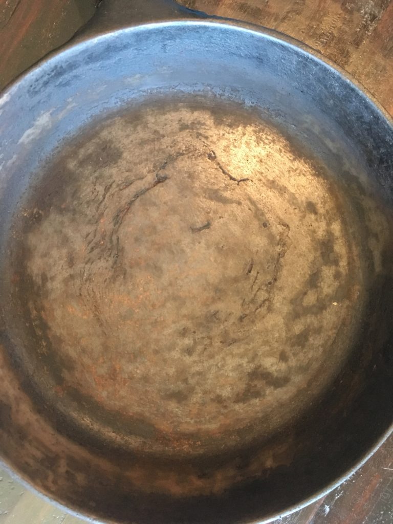 My pan after several hours worth of scrubbing away its seasoning.